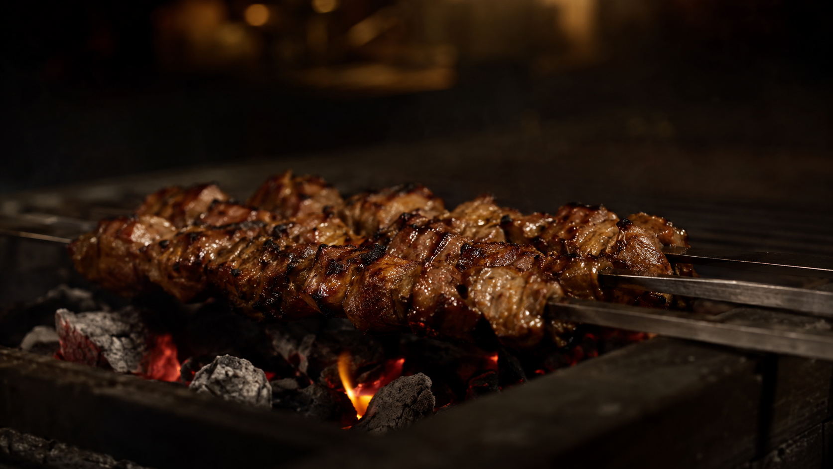 Meat skewers cooking over glowing charcoal